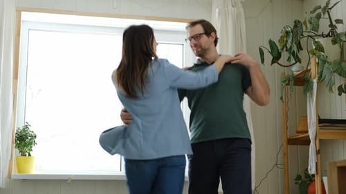 Couple Dancing Together Lovingly in Bright Home
