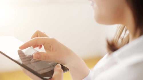 Woman Using Tablet Device Indoors