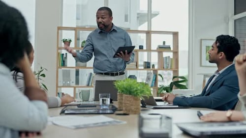 Man Presenting to Colleagues in a Modern Office