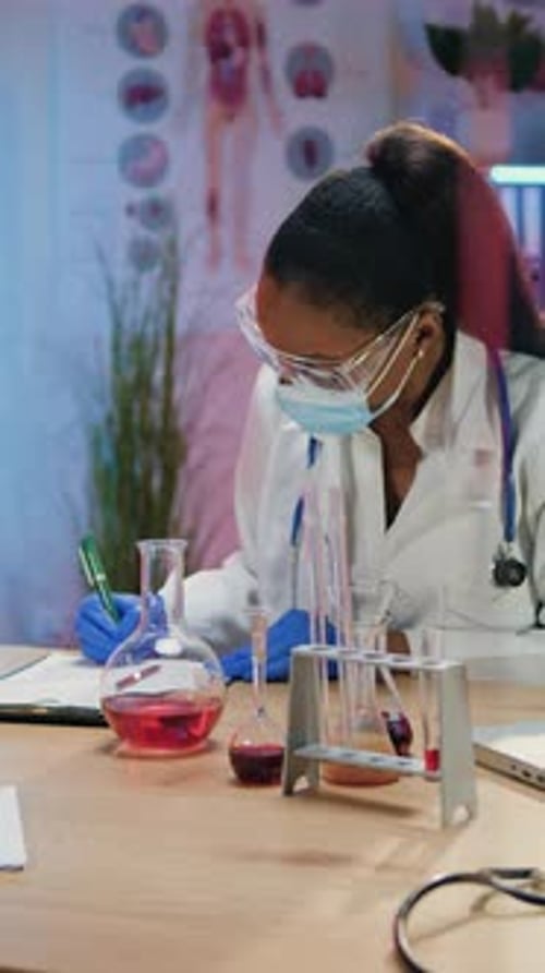 Focused Woman Scientist Working in Medical Laboratory