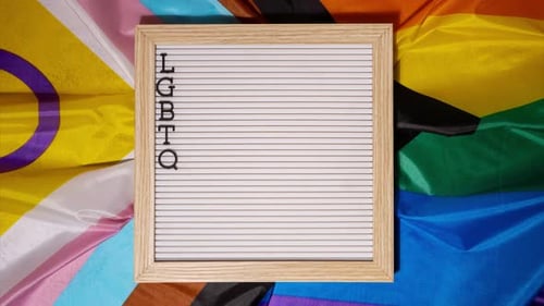 LGBTQ+ Pride Letter Board on Rainbow Flag