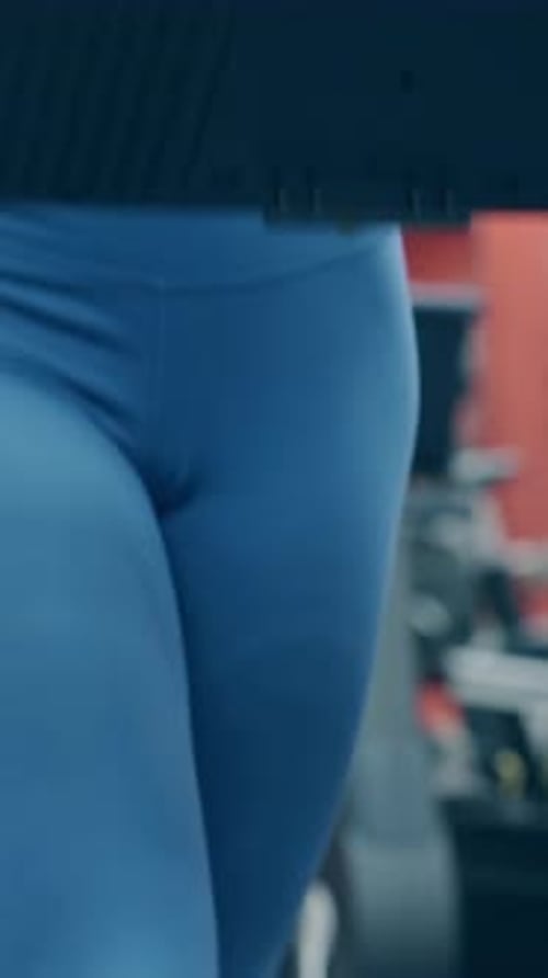 Close View Pretty Young Woman Runs on Treadmill in Gym