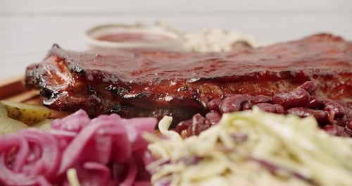 Close Up A Large Plate That Includes Baby Back Ribs with Cherry Chipotle Sauce