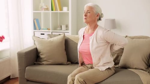 Senior Woman Massaging Sore Neck and Lower Back
