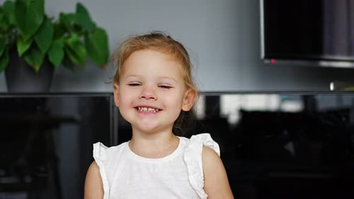Happy Child Smiling for the Camera Indoors
