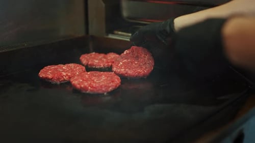 Tasty Close Up Footage of a Meat Patty Being Prepared on a Griller. Fresh Ground Beef is Being Put