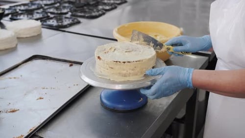 Pastry Chef Spreading Buttercream On Layered Cake Professional Bakery Work