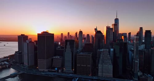 View of Manhattan, New York at sunset. Amazing orange sky behind the skyline at backdrop.