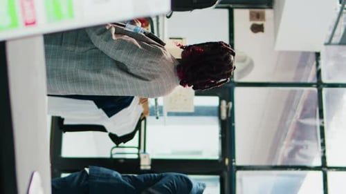 Vertical Video Pregnant Woman Looking at Trendy Merchandise on Stand Hangers