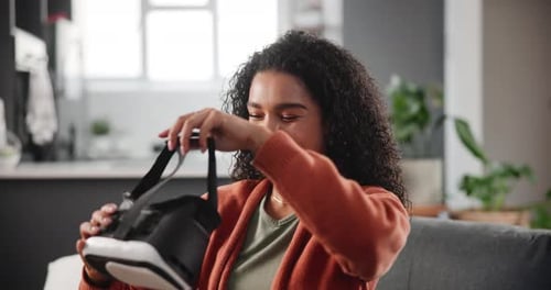 Woman Puts on Virtual Reality Headset at Home
