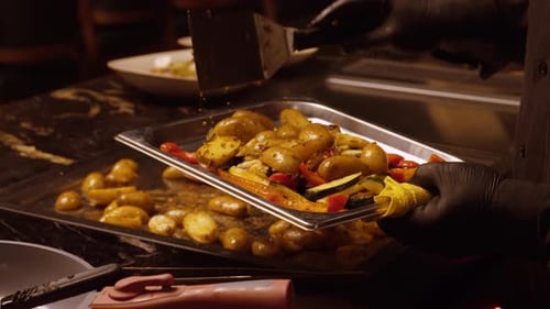 Chef Plates Potatoes and Vegetables in Restaurant Kitchen