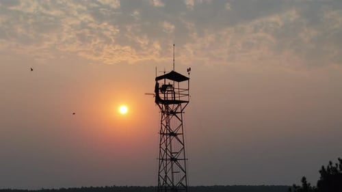 Sunset Behind a Fire Watchtower, Wildfire Detection and Environmental Awareness