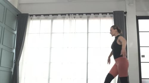 Friends practice ballet dance at studio.