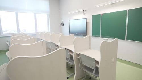 Empty Modern Classroom with Desks and Chairs