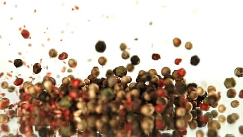 Colorful Peppercorns Falling and Piling on a Surface