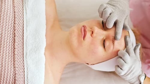 Woman Receiving Relaxing Facial Massage at Spa