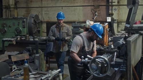 Diverse Technicians Assembling Machinery Equipment at Factory