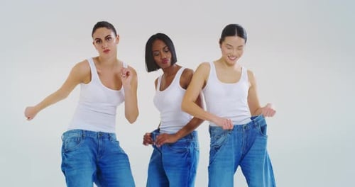 Three Young Women Dancing in Oversized Blue Jeans