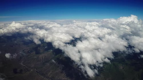 Aerial View of Clouds Over Mountainous Terrain