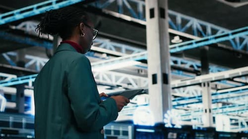 Writing Code Tablet and Female Programmer Walking in Data Center