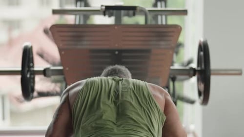 Man Doing Pushups in Gym with Weight Equipment