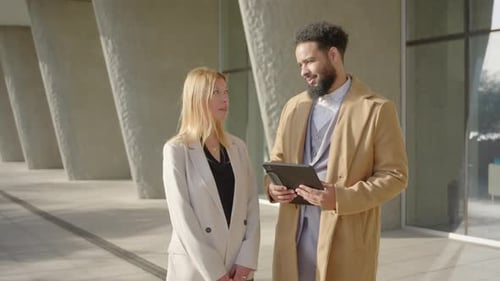 Business Professionals Discussing Plans Near Modern Building