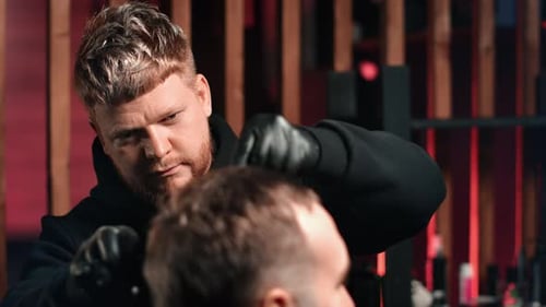 Barber Cutting Hair in Modern Barbershop