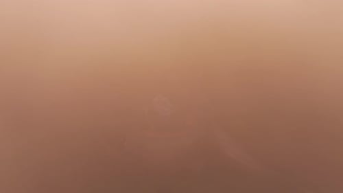 Aerial view of Manasija Monastery in fog at sunset, Serbia.