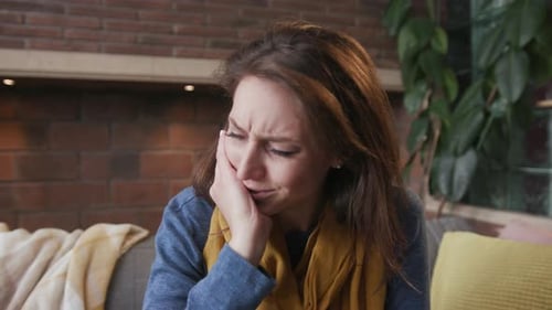 Woman Experiencing Tooth Pain at Home