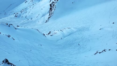 Tranquil Snow Covered Hillside With Rocks Calm Icy Mountain Slope Bathed In Delicate Blue Rays Of