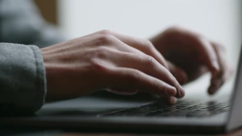Male Hands are Typing on a Keyboard Remote Work on a Laptop Cropped View of a Man Working with