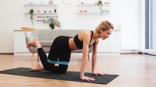 Young Woman Doing Leg Lifts at Home
