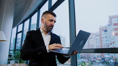 Man With Laptop in Modern Urban Office