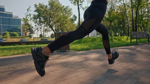 Woman Running in Park on Sunny Day