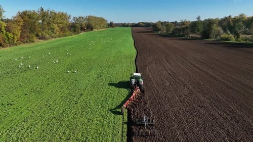 Aerial view of tractor ploughing in Brandenburg, Germany.