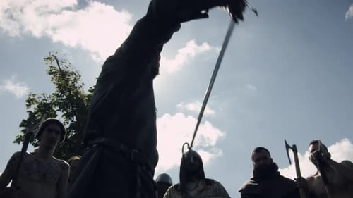 Men Holding Weapons in the Air