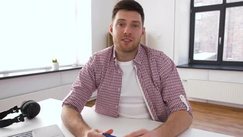 Man Speaking at Desk in Bright Home Office