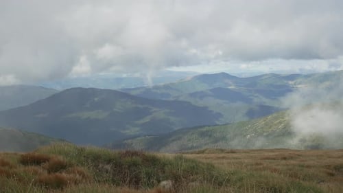 Mountain Range Under Cloudy Sky Wide Shot