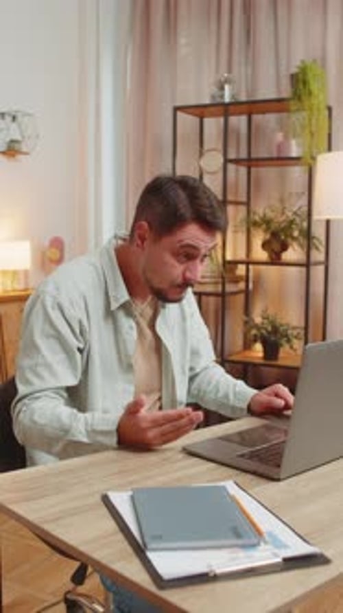 Confident Caucasian Young Male Freelancer Having Video Call Via Laptop Sitting at Home Office Table