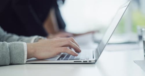 4k video footage of an unrecognisable businessman working on a laptop in an office