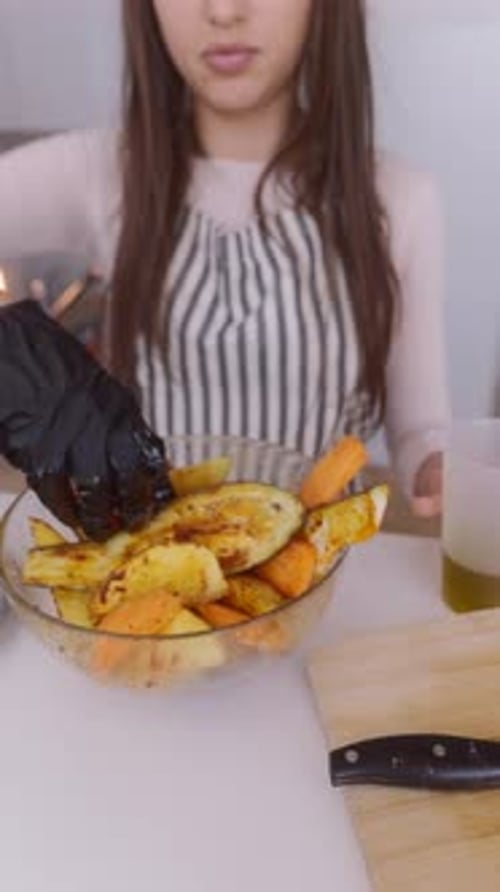 A Woman is Creating a Colorful Vegetable Dish in Her Kitchen Showcasing Her Cooking Skills