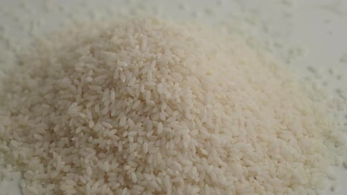 A CloseUp Image Showing White Rice Grains Neatly Arranged in a Pile