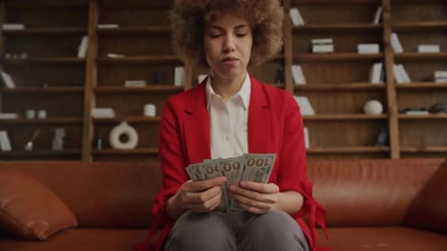 Businesswoman Counting Cash Money in Office