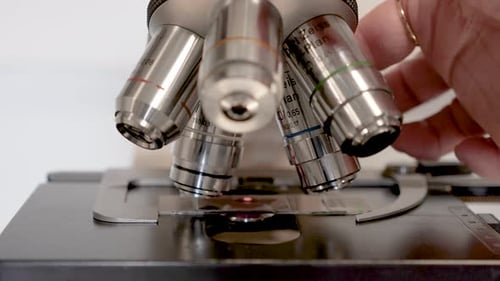 Close Up of Microscope Adjusting Transparent Slide