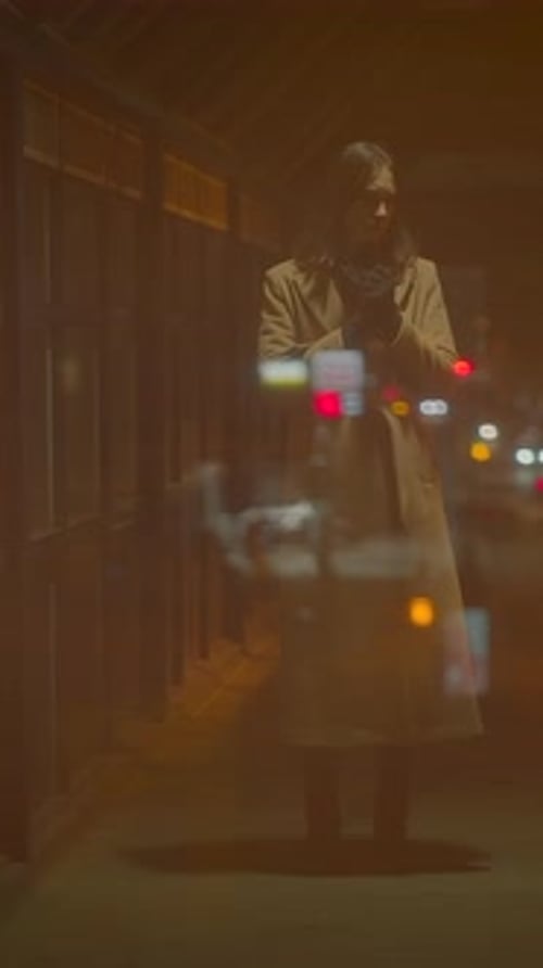 A Mysterious Figure Stands Alone in an Urban Setting Under the Night Skys Enchantment