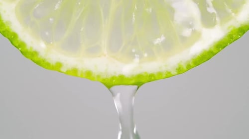Close-Up of a Lime Slice with Dripping Water