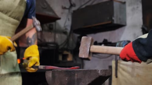 Blacksmiths Shaping Red Hot Metal at Anvil