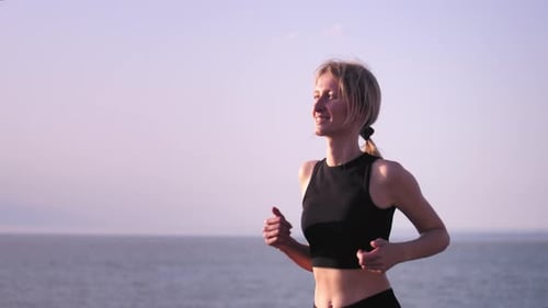 Fitness, woman jogging on beach for health. Training or exercise,