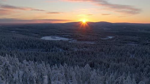 Stunning sunrise scenery above mountains and arctic woods in the north - AERIAL