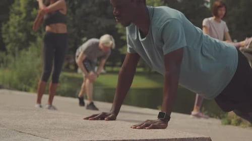 Group Exercises in Urban Park on Sunny Day